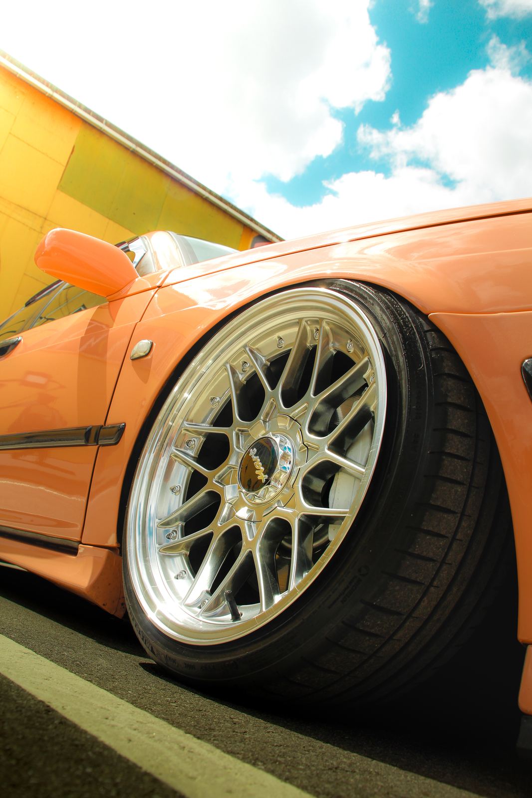 Wheel close-up against yellow building