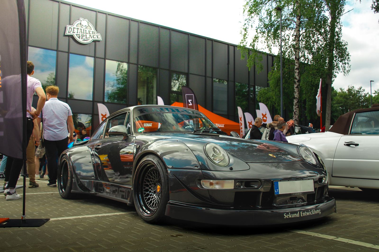 Black widebody Porsche 993 at a car meet