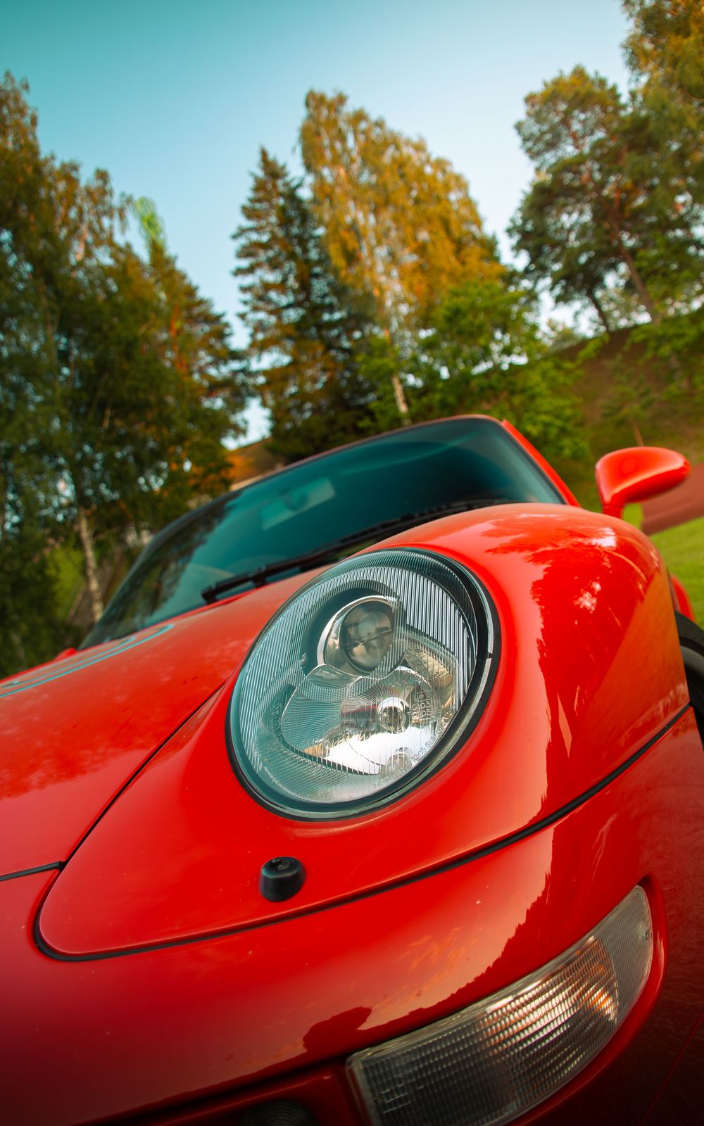 Porsche 993 headlight detail at golden hour